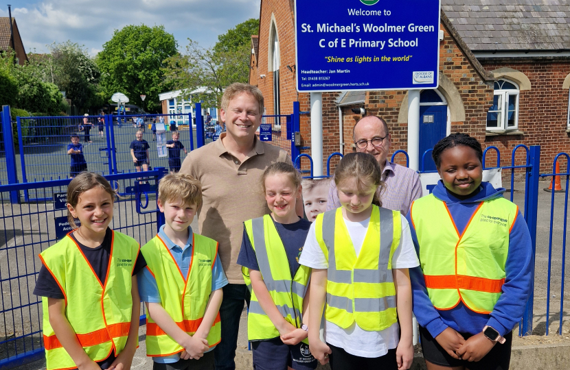 Grant and ambassadors outside the school