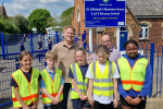 Grant and ambassadors outside the school