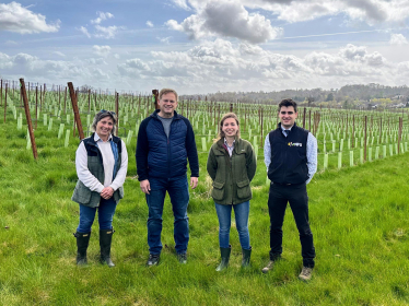 Grant standing with the Buisman family at the vineyard